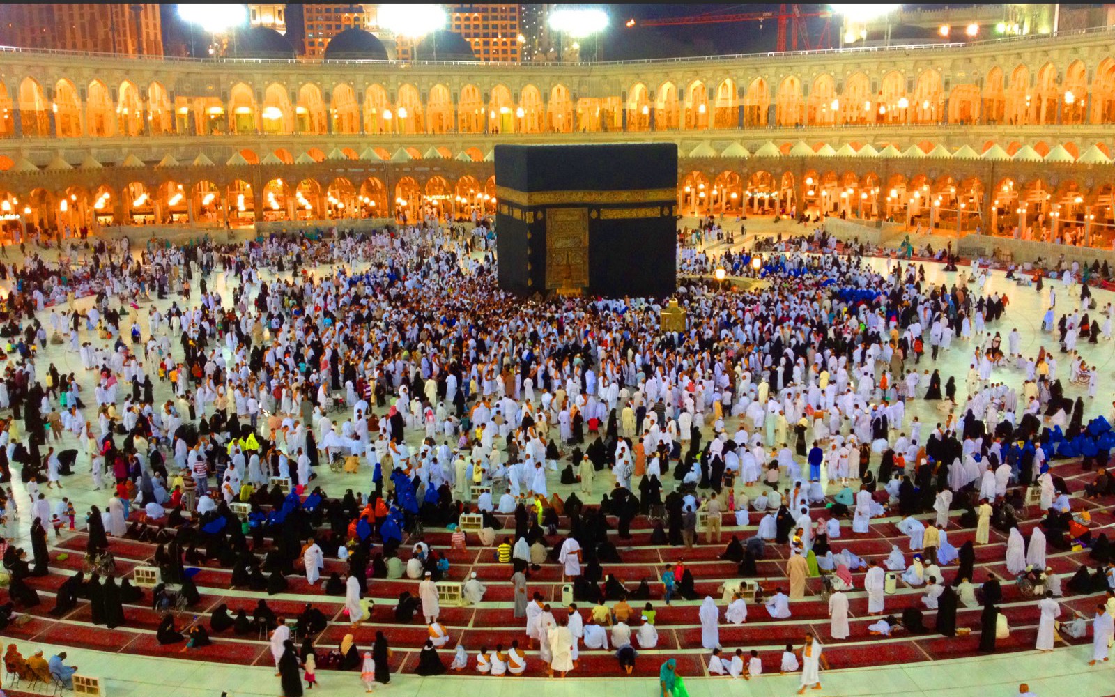 Pilgrims performing tawaf around the Kaaba at night
